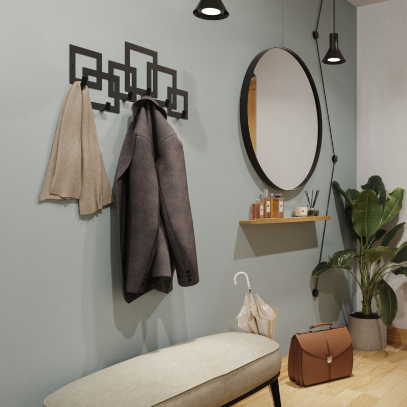 Μαύρη μεταλλική κρεμάστρα έξι θέσεων με σχέδιο κύβους τοποθετημένη σε τοίχο στο χωλ δίπλα από καθρέφτη