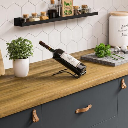 Μία μαύρη μεταλλική βάση για μπουκάλι κρασιού με ένα μπουκάλι τοποθετημένο επάνω σε πάγκο κουζίνας